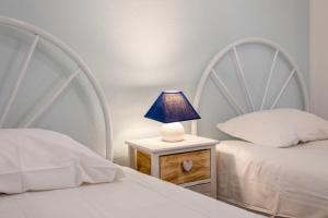 - une chambre avec 2 lits et une lampe sur une table de chevet dans l'établissement Albufeira BeachFront RC, à Albufeira