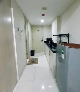 a hallway of a room with a counter and a kitchen at Warhol Residence at Louise Kienne Simpang Lima Semarang in Semarang