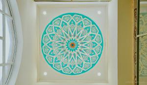 a blue and white mandala painting on a wall at Hotel Bankir Khiva in Khiva