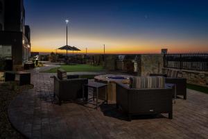 a patio with chairs and a table and an umbrella at TownePlace Suites El Paso North in Sunrise Acres