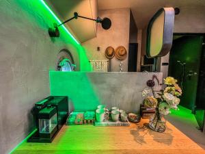 a room with green lighting and a table with flowers at Boat & Boost Amsterdam in Amsterdam