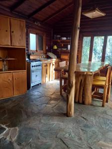 a large kitchen with a table and a stove at Mystic House in Mar del Plata