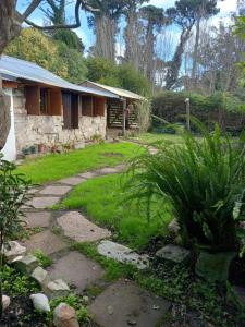a house with a stone pathway in front of a yard at Mystic House in Mar del Plata