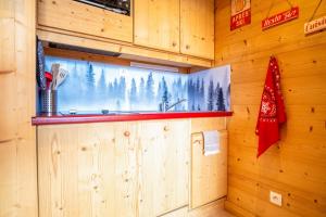 a kitchen with a sink in a wooden wall at Apartment with a superb view in l'Alpe d'Huez - Welkeys in LʼHuez