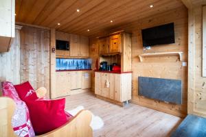 a living room with a couch and a flat screen tv at Apartment with a superb view in l'Alpe d'Huez - Welkeys in LʼHuez