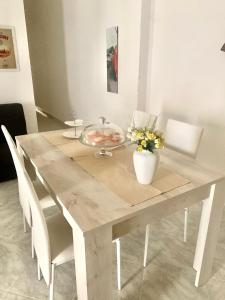 a wooden table with a bowl of food on it at Da Angela in Orgosolo