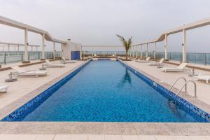 a swimming pool on the roof of a building at A Perfect Escape - Sea facing in Ras al Khaimah