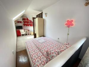 a bedroom with a bed with a flower on the wall at Casa Hărșan in Sovata