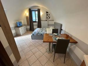 a bedroom with a table and a bed in a room at CASA VACANZA PIEVE in Pisogne