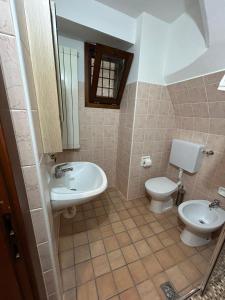 a bathroom with a sink and a toilet at CASA VACANZA PIEVE in Pisogne +22 photos