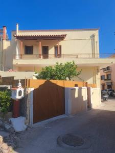 a house with a gate in front of a house at Castle luxury home in Chios