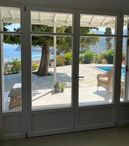 una porta scorrevole in vetro con vista su un patio di Villa Icelle Skopelos Town Sea View Swimming Pool a Skopelos Town