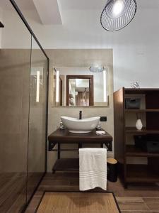 a bathroom with a sink and a mirror at La casa di Asia in Lamezia Terme