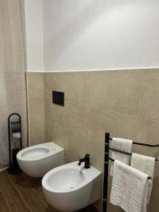 een badkamer met een witte wastafel en een toilet bij La casa di Asia in Lamezia Terme
