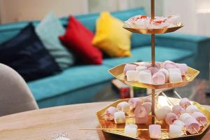 a tray of marshmallows on a stand on a table at 4AS Spa Paris in Verdelot