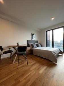 a bedroom with a bed and a desk and a table at City Loft Berlin Mitte in Berlin