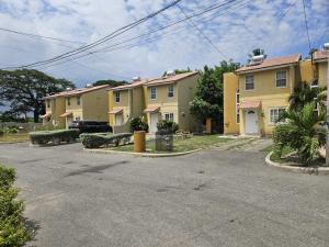 a row of houses in a parking lot at JA-Spain Retreat in Spanish Town