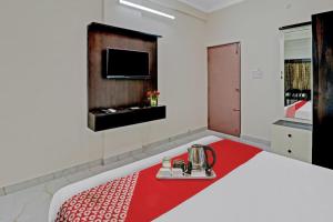 a hotel room with a bed with a red blanket at OYO Nra Residency Near Rajarajeshwari Nagar Metro Station in Bangalore