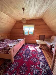 a bedroom with a bed and a couch in a room at Сієста in Svityazʼ