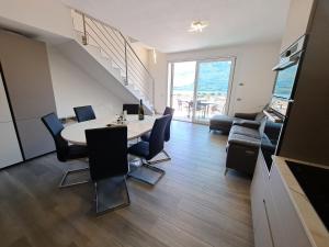 a living room with a table and chairs and a couch at Immobillario - Lakes Dream in Domaso