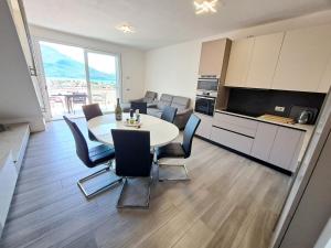 a kitchen and dining room with a table and chairs at Immobillario - Lakes Dream in Domaso