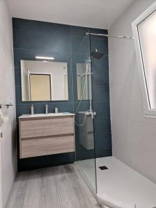 a bathroom with a glass shower and a sink at GUANARTEME 33 in Las Palmas de Gran Canaria