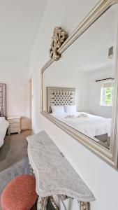 um quarto branco com um grande espelho na parede em Stylish 3 Bedroom House em Galway