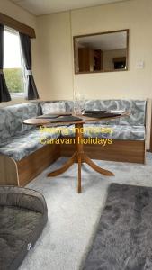 a living room with a coffee table and a couch at Making Memories Holiday Caravan in Skegness