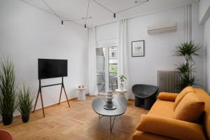 a living room with a couch and a table at H Experience - Funky 1BD apartment in vibrant Nea Smirni in Athens