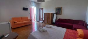 a living room with a bed and a couch at Consoli Crispino in Francolise