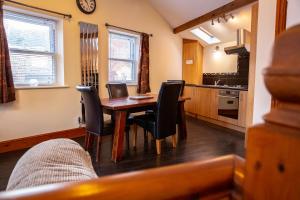 a kitchen and dining room with a table and chairs at Groveside Holiday Lets in Saltburn-by-the-Sea