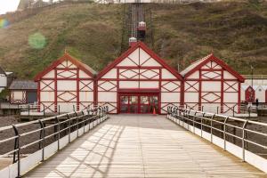 a large red and white building with a bridge at Groveside Holiday Lets in Saltburn-by-the-Sea