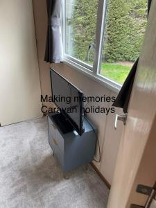 a desk in a room with a window at Making Memories Holiday Caravan in Skegness