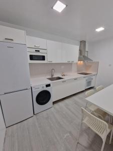 a white kitchen with a sink and a dishwasher at GUANARTEME 33 in Las Palmas de Gran Canaria