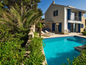 a villa with a swimming pool and a house at Villas Violet & Rosemary in Supetar