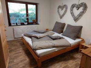 a bedroom with a bed with hearts on the wall at Chalet 32 in Nagel