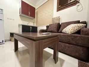 a living room with a couch and a table at mnarat al madina in Al Madinah