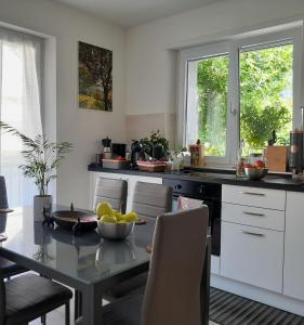 a kitchen with a table with a bowl of fruit on it at Appartment Lodged Mamma Maria in Mattarello