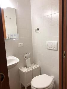 a small bathroom with a toilet and a sink at Il Nido Del Cuculo in Carrara