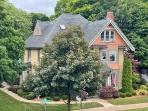 a house with a tree in front of it at The Ludington House in Ludington