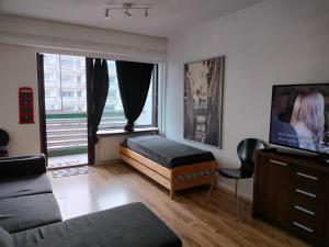 a bedroom with a bed and a large window at apartment in great location in Helsinki