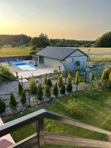 a view of a backyard with a pool and a house at Koniec Świata domek z basenem in Stare Sady