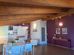 a dining room with a table and chairs and wooden ceilings at B&B Carlotta in Montesilvano