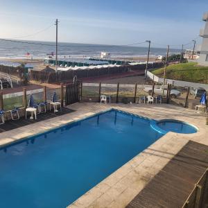 a swimming pool with a view of the beach at Departamento Miranda in Villa Gesell