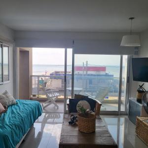 a room with a bed and a view of an airport at Departamento Miranda in Villa Gesell