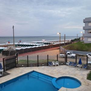 a swimming pool with a view of the beach at Departamento Miranda in Villa Gesell