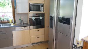 a kitchen with a refrigerator and a sink at Calm House in suburbs of Cracow in Michałowice