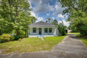 a small white house with a driveway at Historic Augusta Getaway with Screened Porch! in Augusta