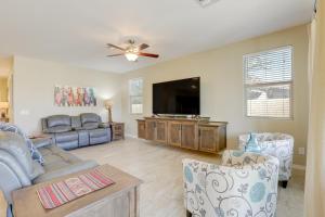a living room with a couch and a flat screen tv at Resort Amenities and Patio at 55 and Goodyear Escape! in Goodyear