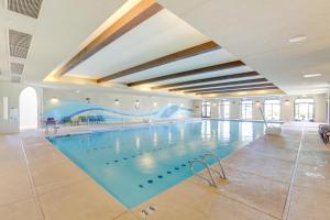a large swimming pool in a large building at Resort Amenities and Patio at 55 and Goodyear Escape! in Goodyear
